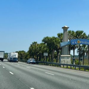 Highway with a Thank you for Visiting Florida sign on the side